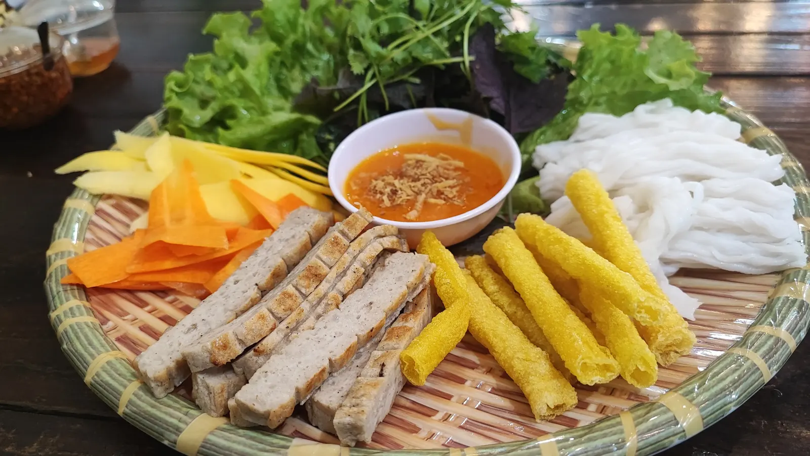 Vietnamese nem and cha food platter with fresh herbs and dipping sauce