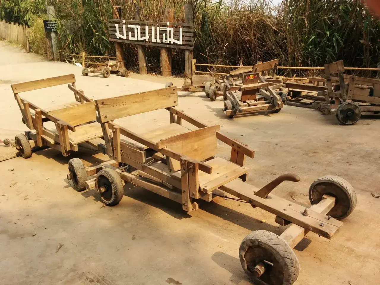 Thai gravity cart at Mon Jam with primitive brakes symbolizing road safety in Thailand